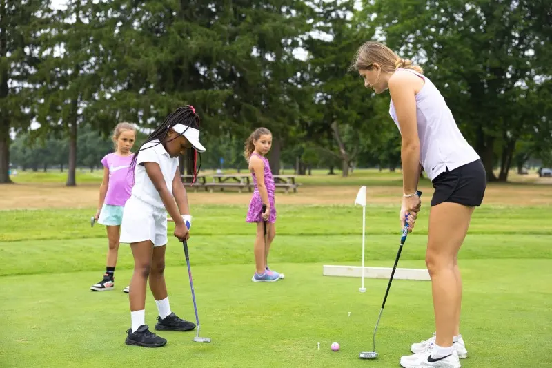Coaches guide juniors on the putting green
