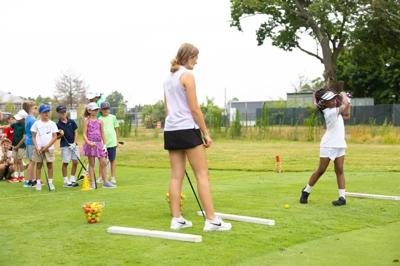 Juniors and a coach on the practice green