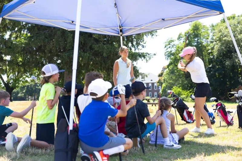 Juniors in the shade of a tent between drills
