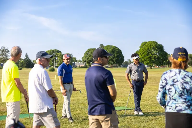 An instructor talks a group of adult students through a drill