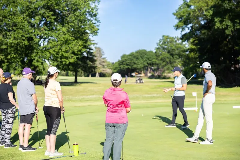 Juniors and coaches on the practice green