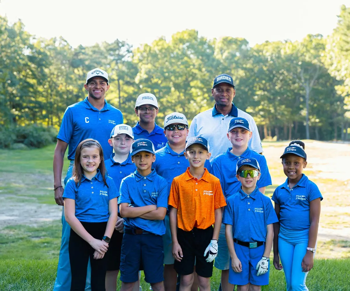 Jones Golf Academy PGA Jr. League players in matching blue jerseys with their coaches
